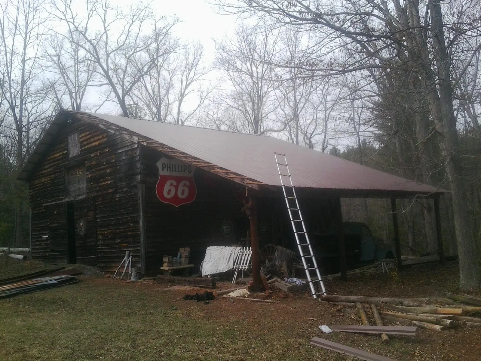 New metal roof on an open sided timber barn with a vintage sign in Valley